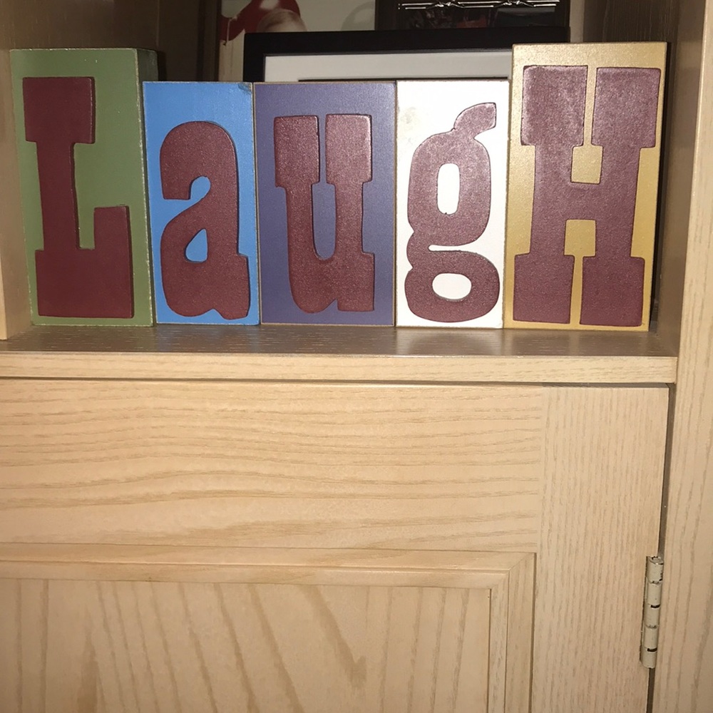 Small Block Letters Spelling LAUGH